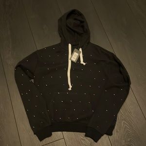 Katie J NYC black hoodie with multicolored rhinestones.